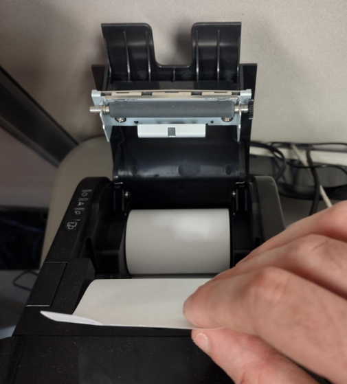 Replacing the paper roll in a POS Receipt Printer